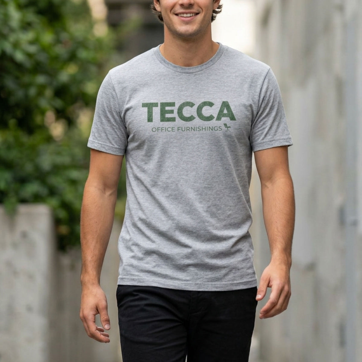 Person wearing Heather gray TECCA Office Furnishings tee inspired by The Chair Company. Bella+Canvas tim robinson shirt comedy.