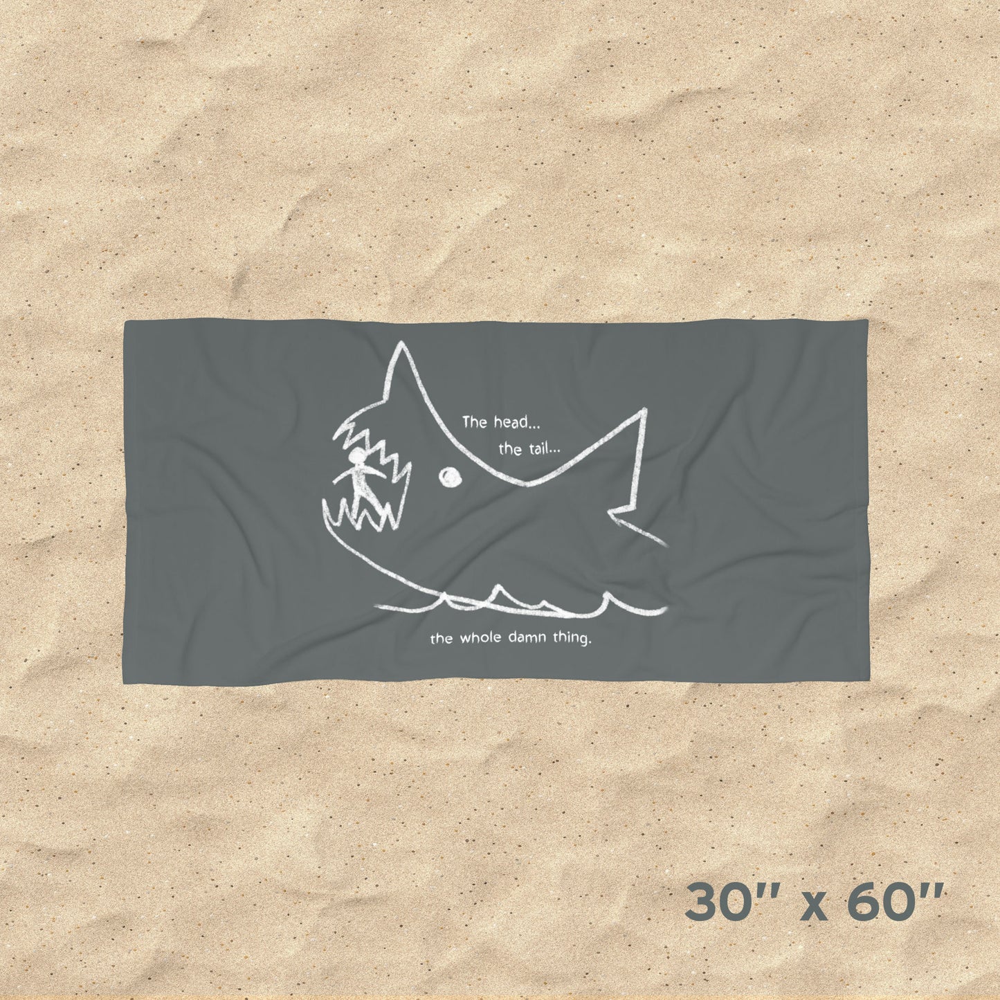 Overhead view of Jaws beach towel with gray Quint chalkboard shark drawing and “the whole damn thing” quote draped on beach chair, size 30x60.