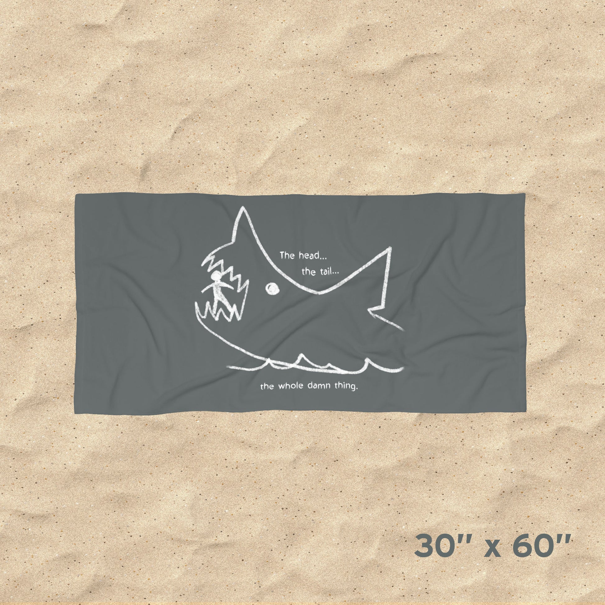 Overhead view of Jaws beach towel with gray Quint chalkboard shark drawing and “the whole damn thing” quote draped on beach chair, size 30x60.