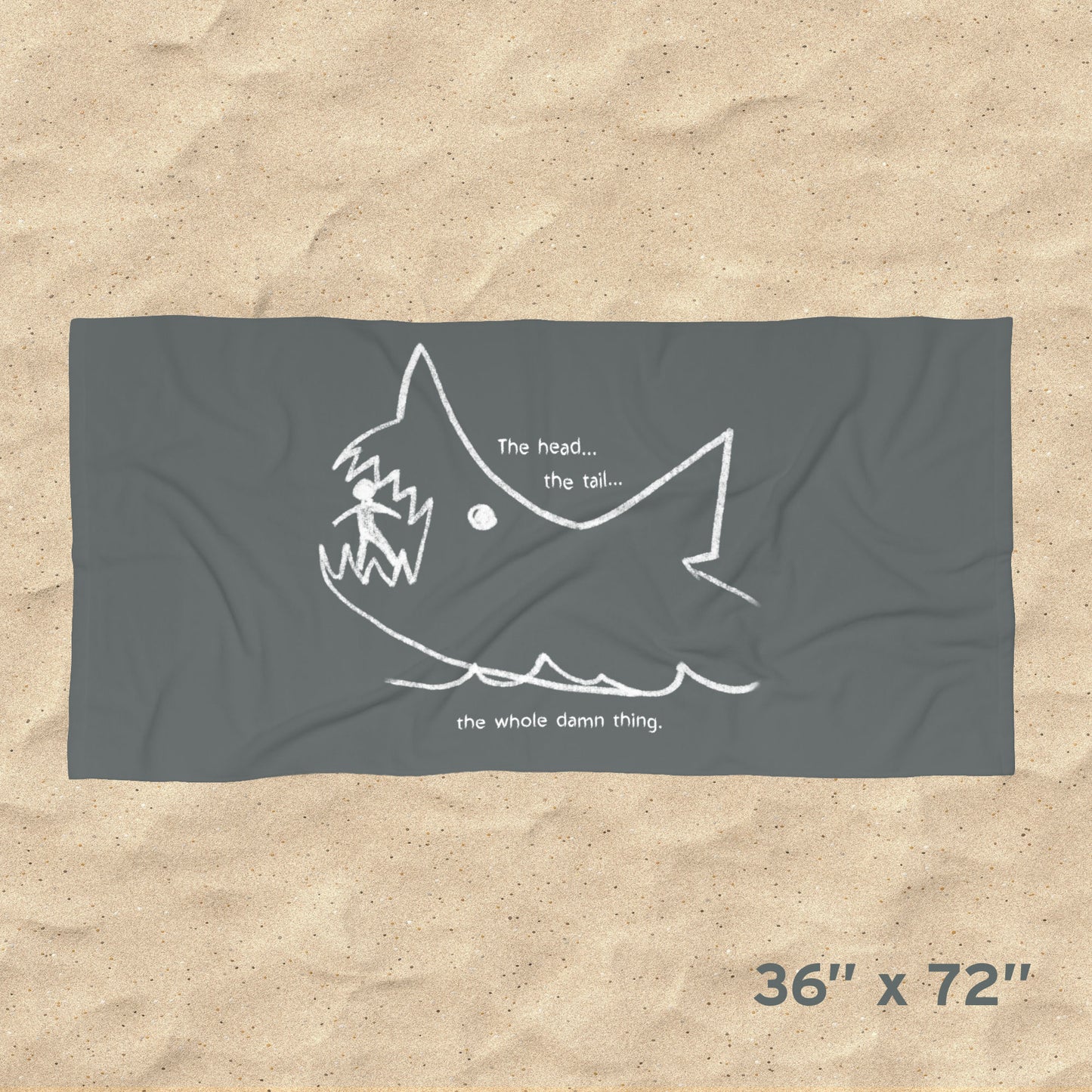 Overhead view of Jaws beach towel with gray Quint chalkboard shark drawing and “the whole damn thing” quote draped on beach chair, size 36x72.