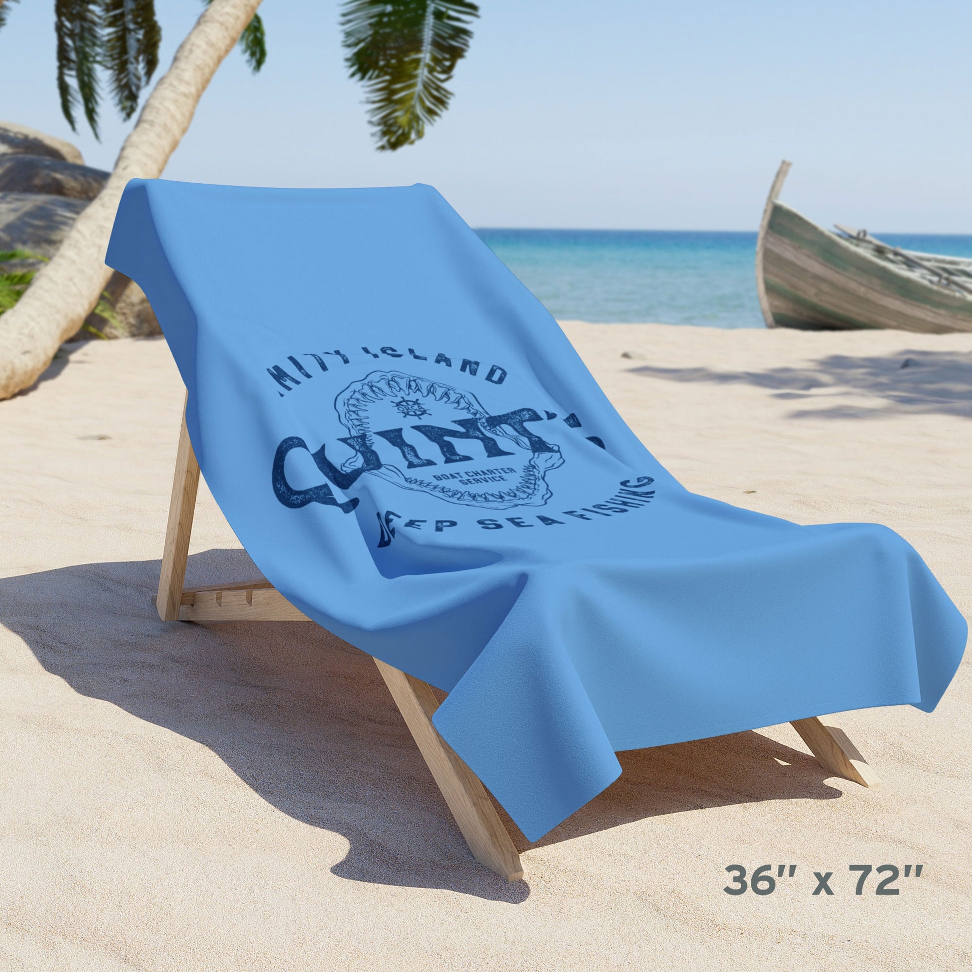 36x72 Blue beach towel with Quint’s Deep Sea Fishing logo, vintage distressed Jaws inspired design, shown draped over a beach chair.