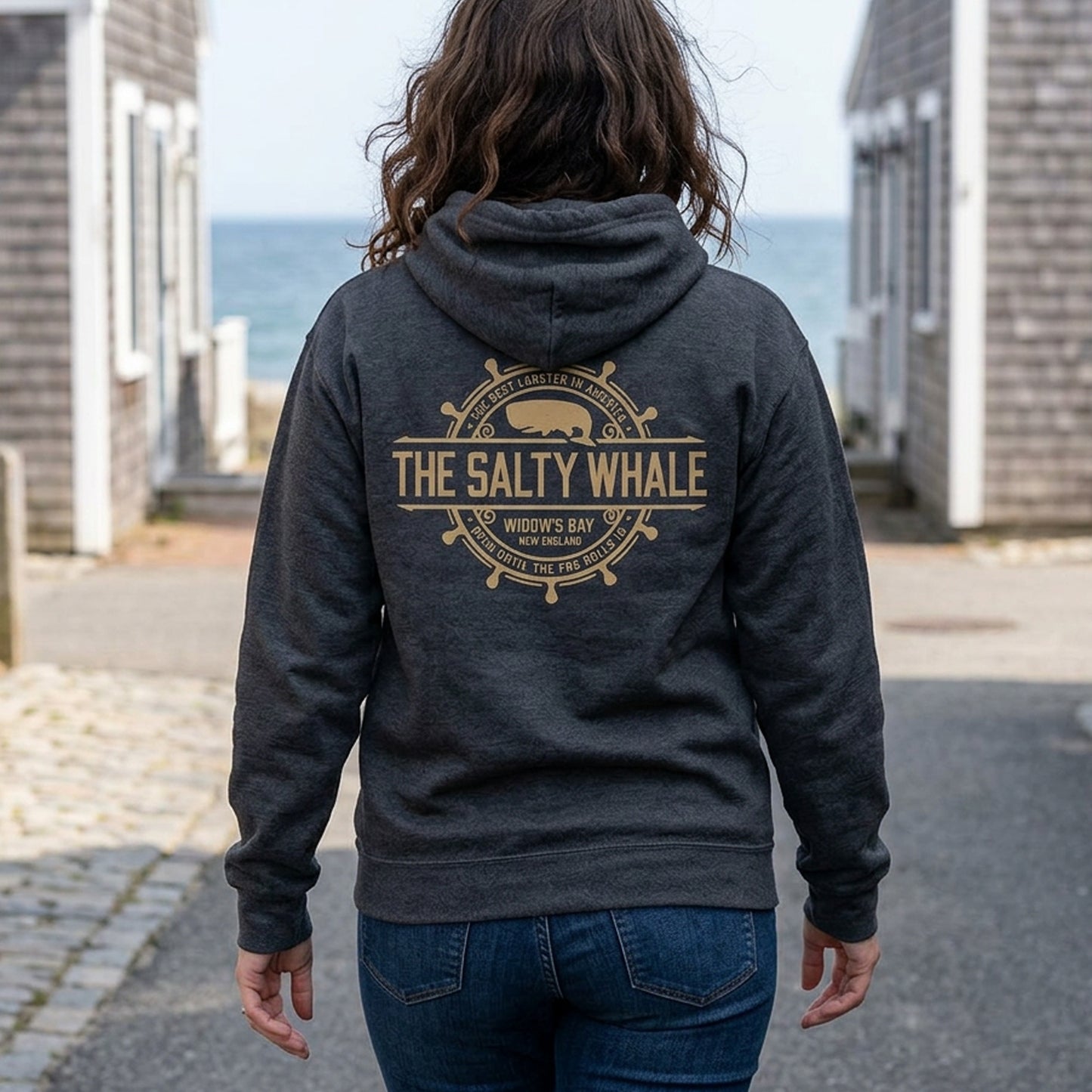 person wearing Gildan full-zip hoodie with distressed Widow's Bay Salty Whale logo across the back