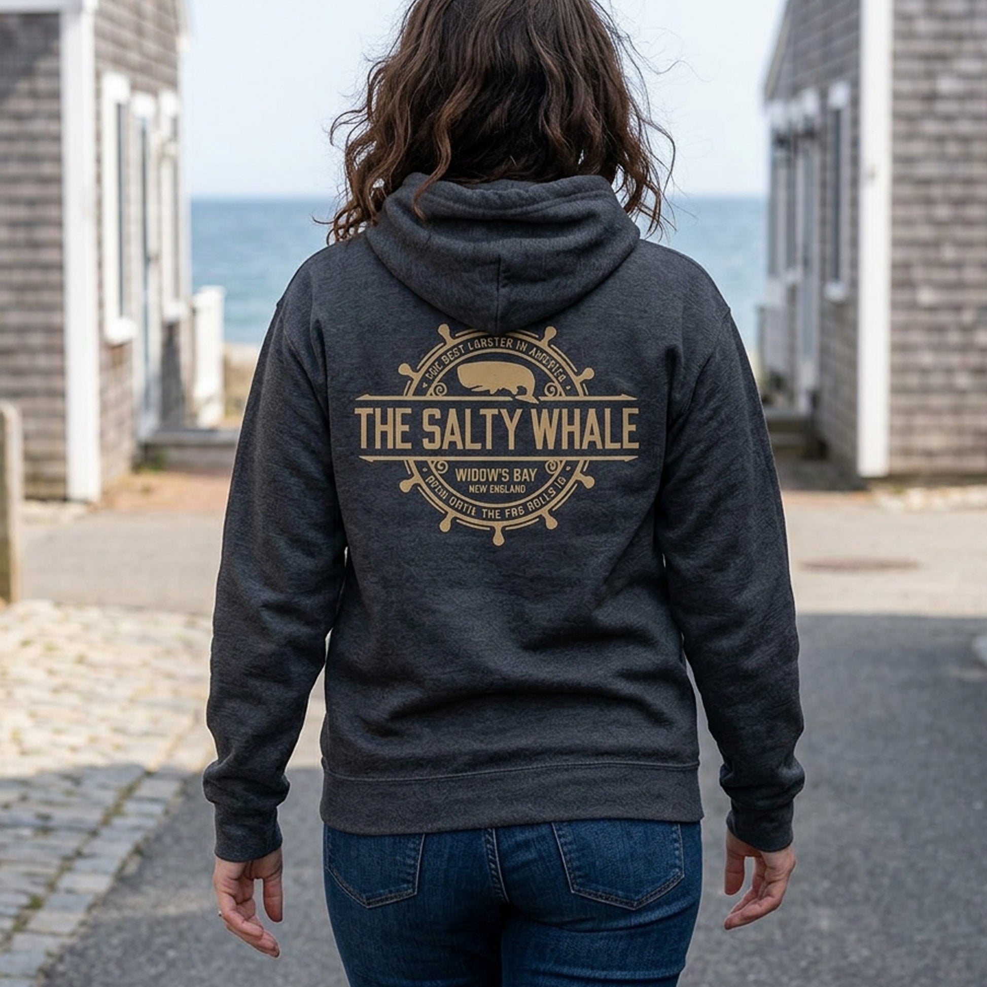 person wearing Gildan full-zip hoodie with distressed Widow's Bay Salty Whale logo across the back