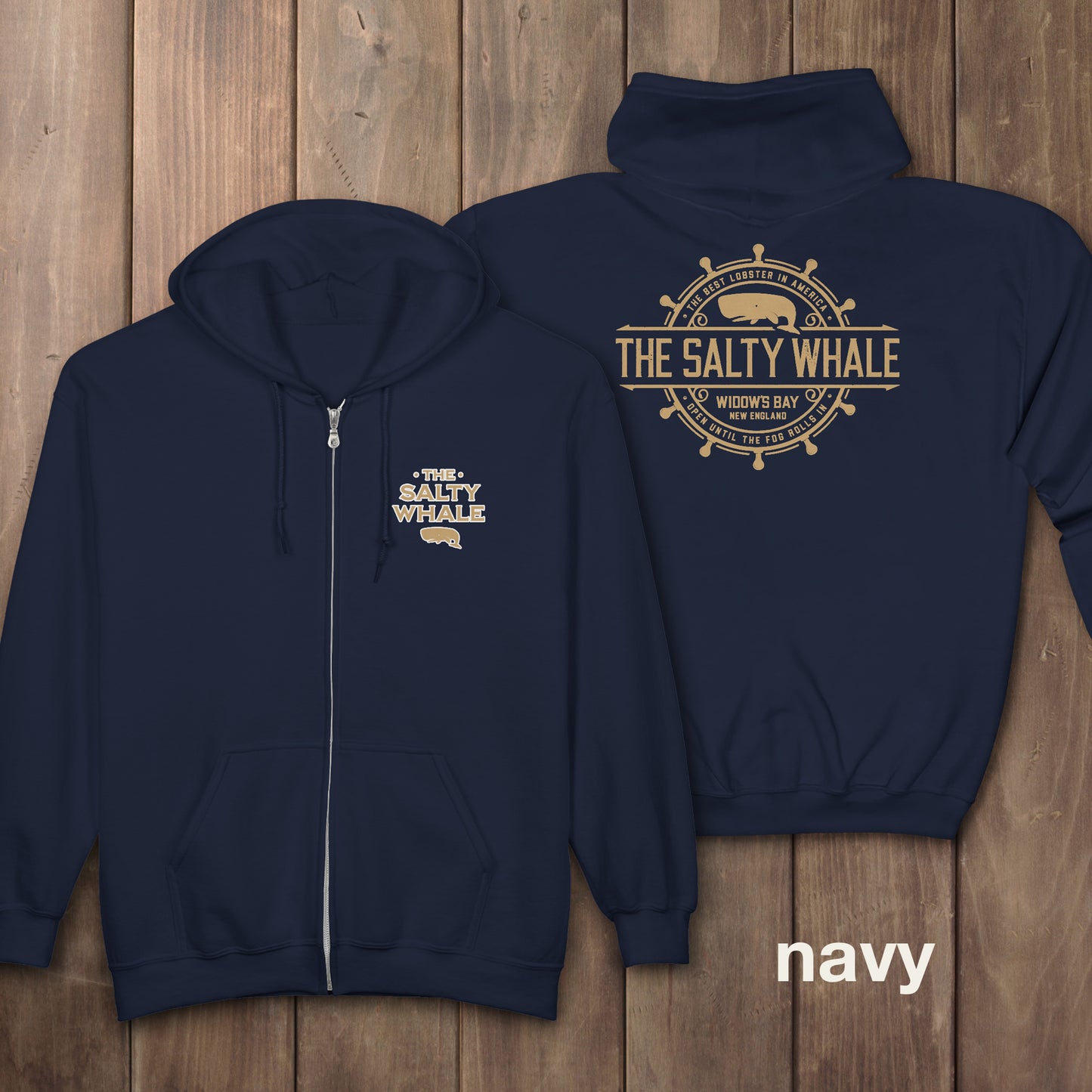 Navy blue Gildan full-zip hoodie with Widow's Bay Salty Whale logo on front and gold distressed maritime crest across the back