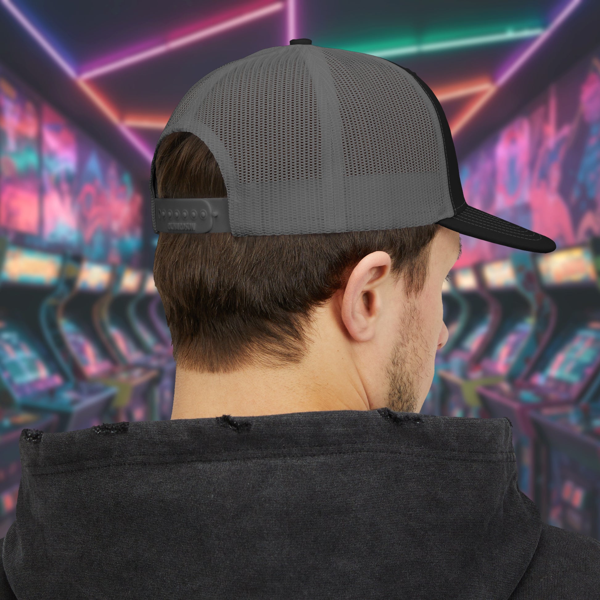 Rear view of Man wearing Black and charcoal Richardson 112 snapback trucker cap with 'Flynn’s Arcade' neon logo inspired by TRON.