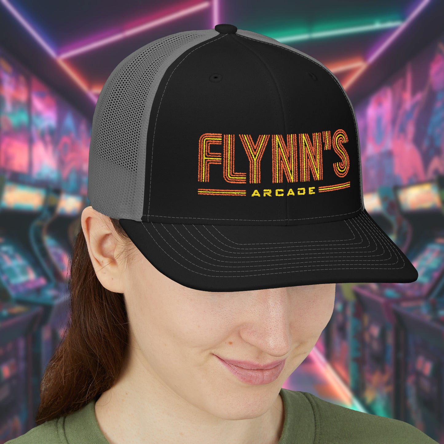 Woman wearing Black and charcoal Richardson 112 snapback trucker cap with 'Flynn’s Arcade' neon logo inspired by TRON.