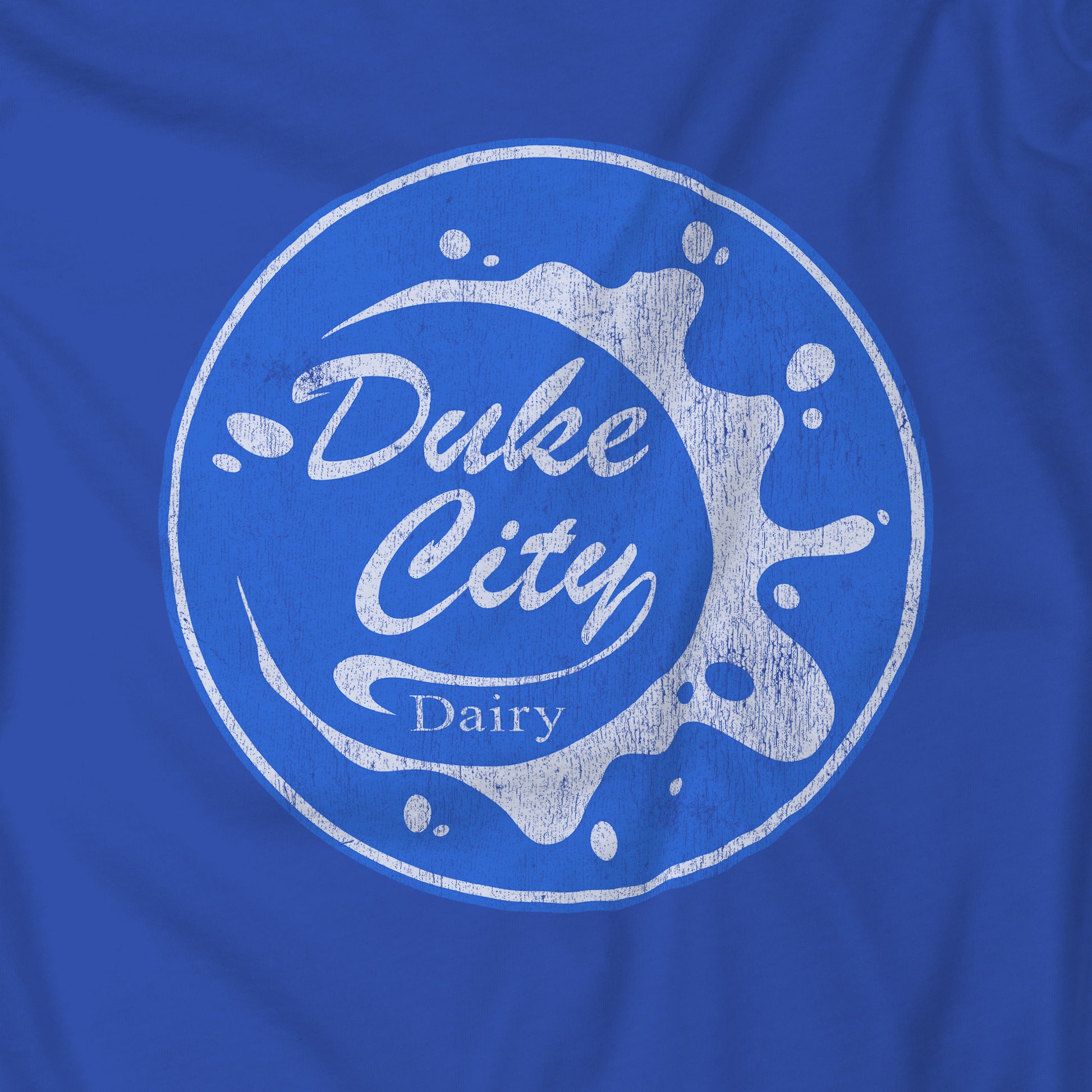 Closeup of blue hoodie with 'Duke City Dairy' logo from Pluribus