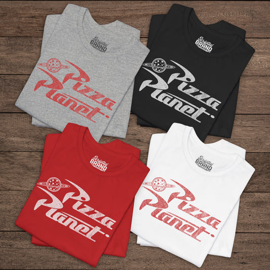 Four folded t-shirts with distressed Pizza Planet logo inspired by the Toy Story movies.