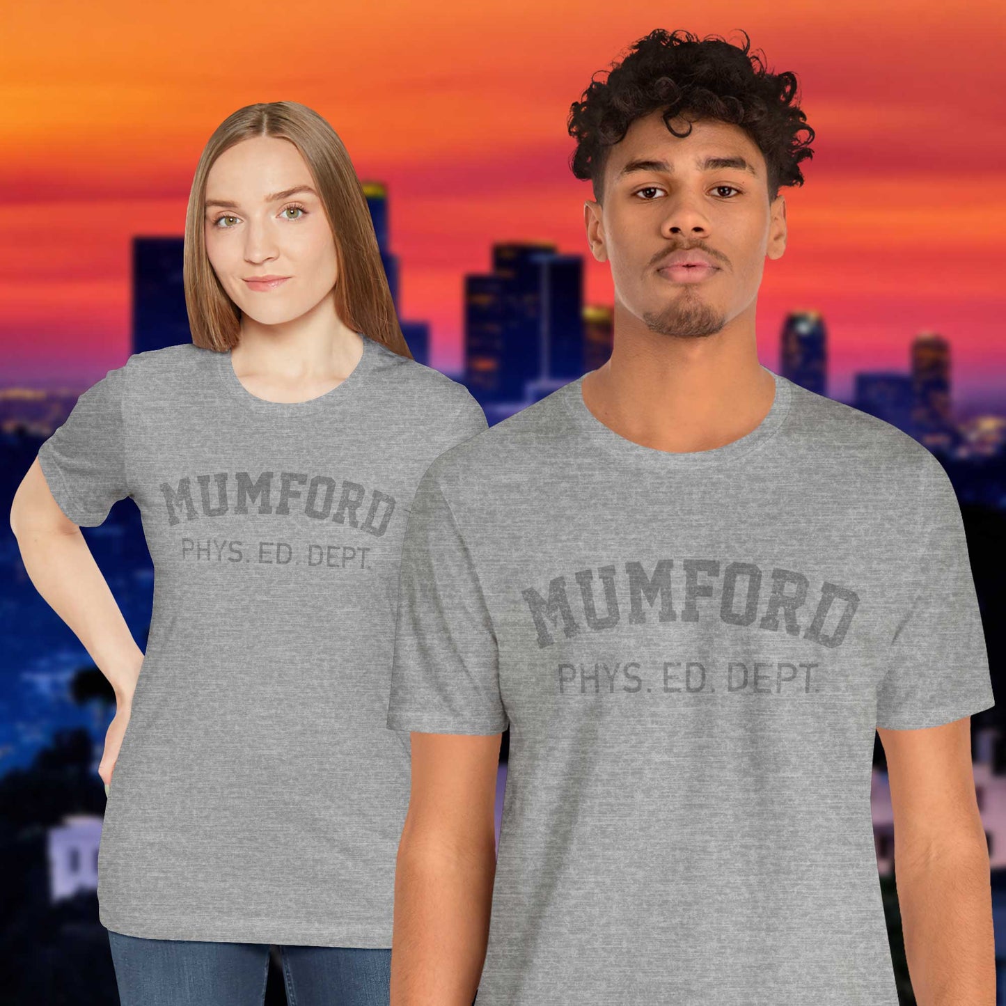 2 models wearing Athletic Heather Grey Soft Bella+Canvas 3001 short-sleeve t-shirt gym tees featuring the Mumford Phys Ed logo graphic that Eddie Murphy wore as Axel Foley in the movie Beverly Hills Cop in a vintage distressed style, sold by ScriptedBrand.