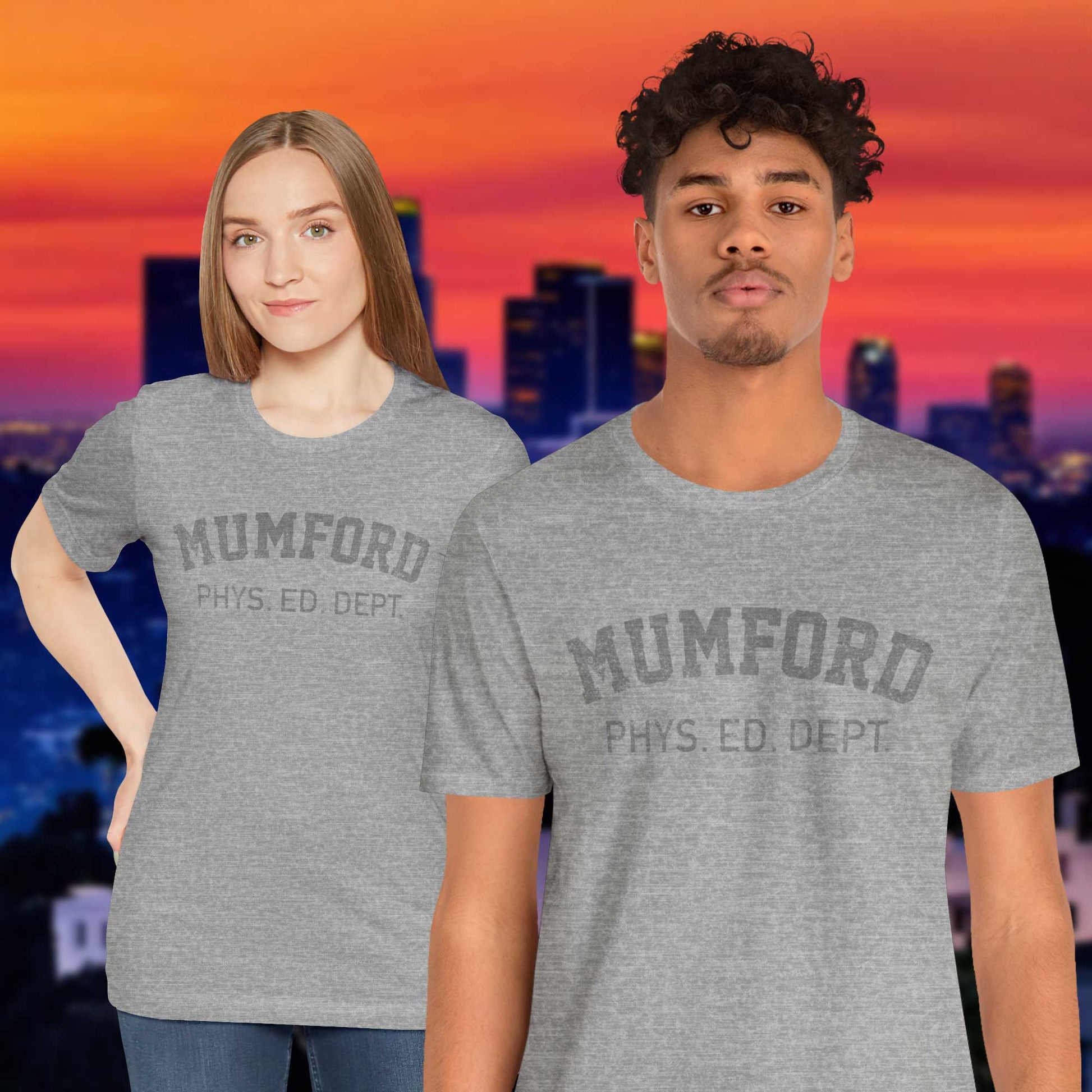 2 models wearing Athletic Heather Grey Soft Bella+Canvas 3001 short-sleeve t-shirt gym tees featuring the Mumford Phys Ed logo graphic that Eddie Murphy wore as Axel Foley in the movie Beverly Hills Cop in a vintage distressed style, sold by ScriptedBrand.