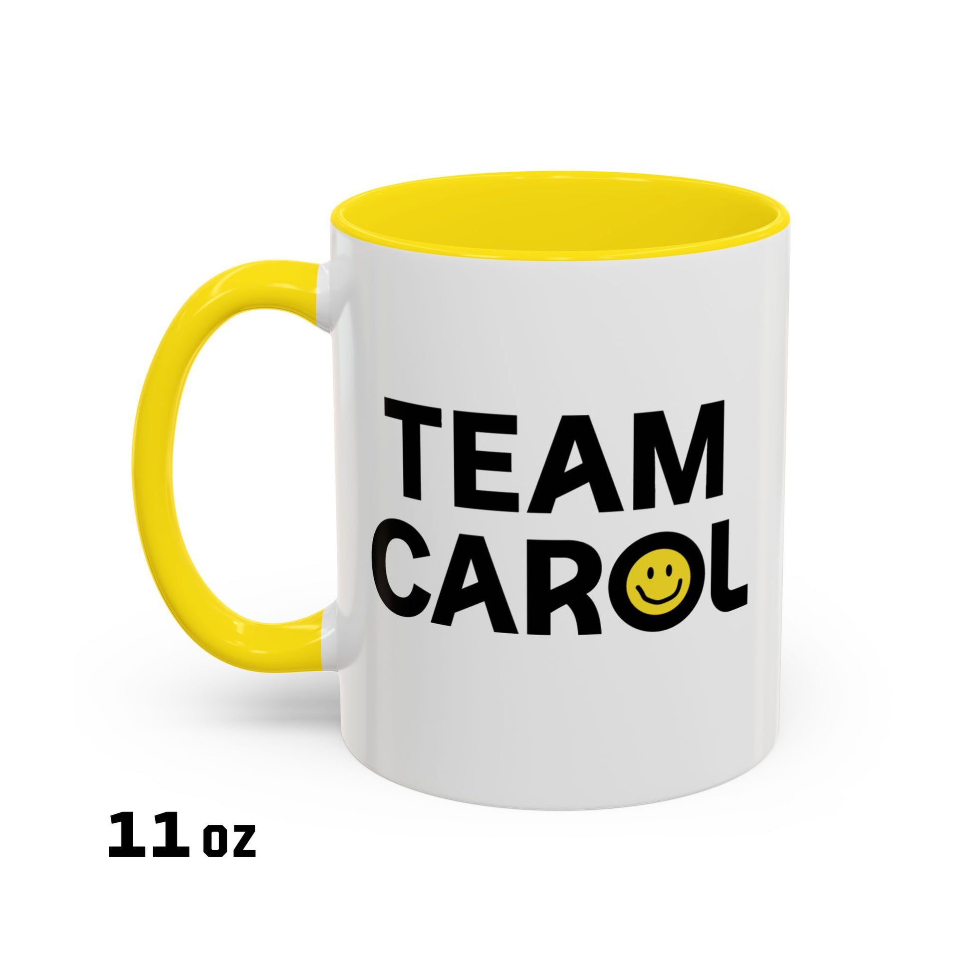 11 oz ceramic accent mug with yellow handle and interior, TEAM CAROL text and smiley face from Pluribus, shown on white background