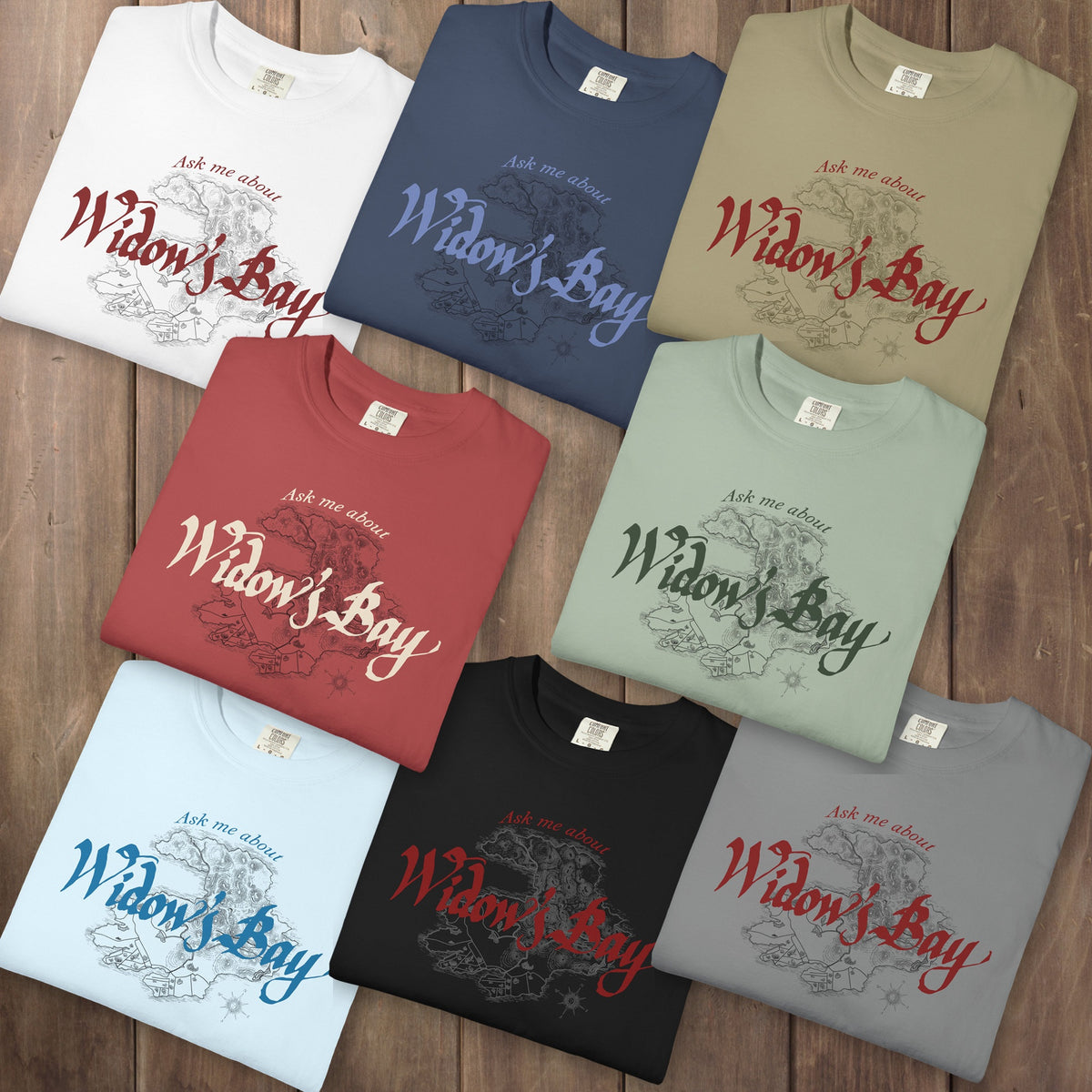 Eight folded Comfort Colors tees with a vintage island map and antique "Ask Me About Widow's Bay" type from the Apple TV show