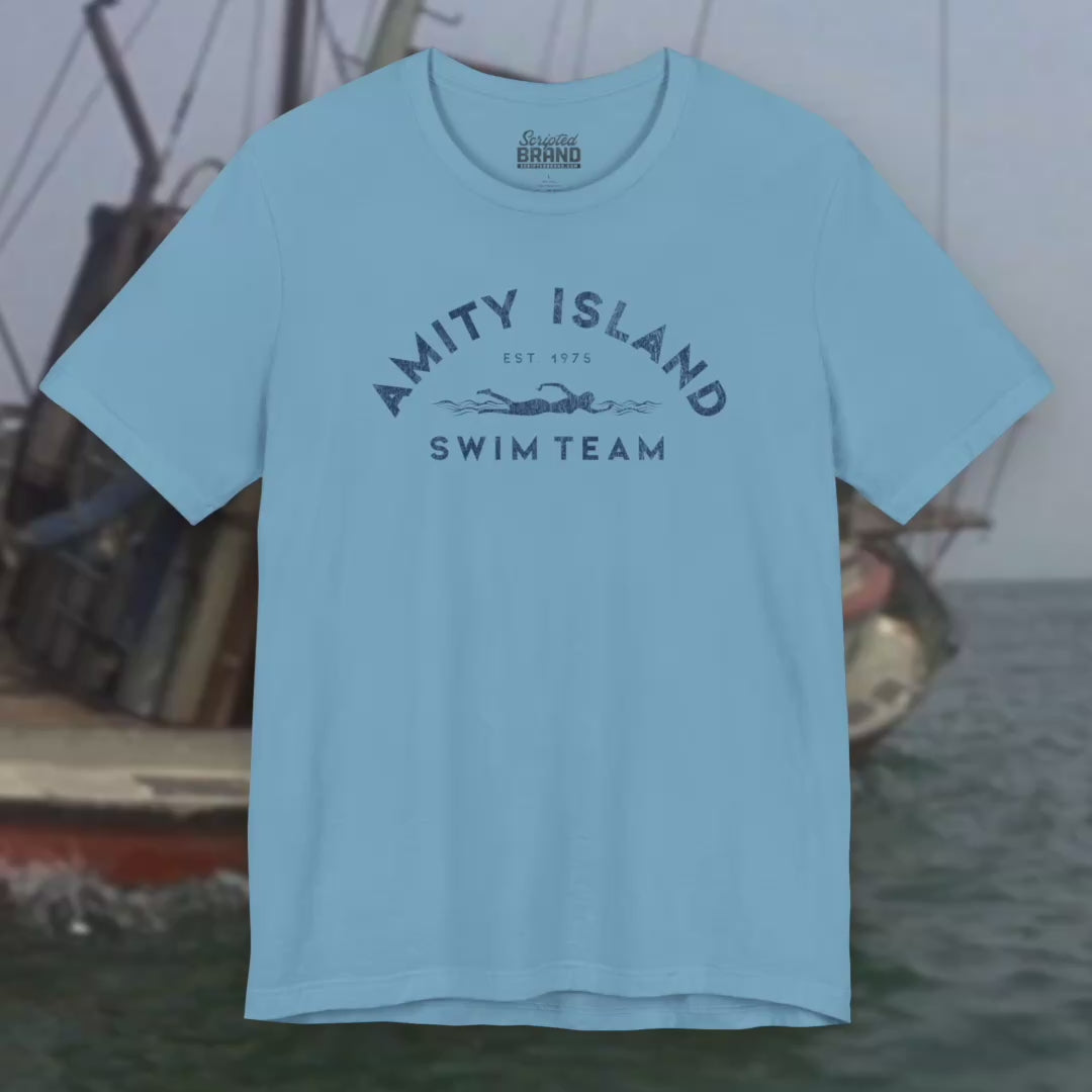 Video of Soft unisex Bella+Canvas 3001 short-sleeve t-shirts featuring an Amity Island Swim Team logo graphic, designed by ScriptedBrand, and  inspired by the movie Jaws in a vintage distressed style.