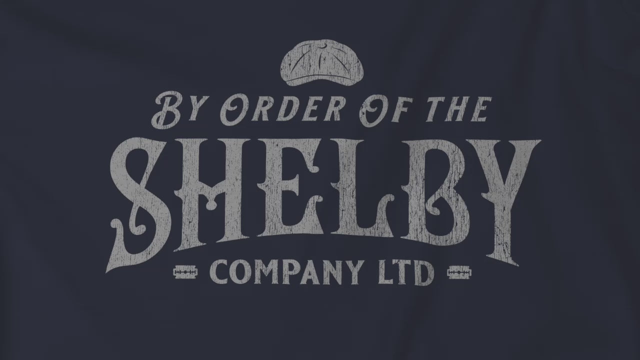 Video of Shelby Company Ltd long-sleeve tee with vintage logo from Peaky Blinders, featuring flat cap and razor blades.