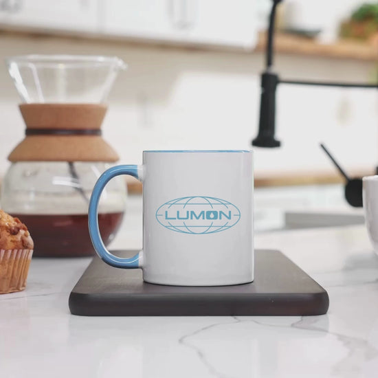 Video of a White Ceramic Mug (11 oz) with the blue Lumon Industries logo on both sides, inspired by the Apple TV show Severance.