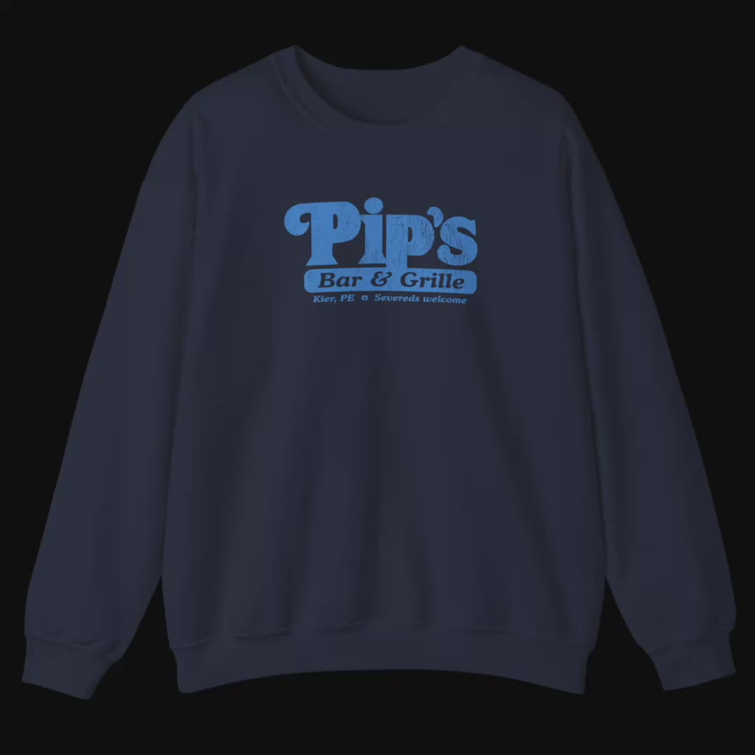 Video featuring Soft Gildan 18000 sweatshirt featuring the Pips Bar and Grill logo Severeds Welcome from the TV show Severance in a vintage distressed ink-stamped worn-in style.