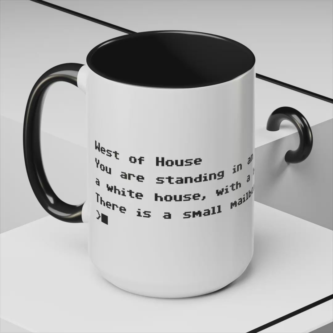 Video of White ceramic accent mug with black handle and interior, Zork “West of House” opening line text wrapped in black print