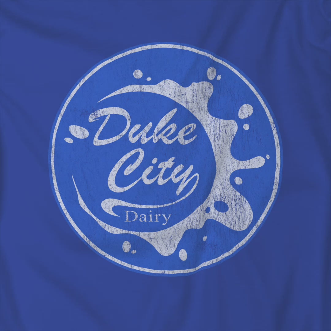 Video of sweatshirt with blue vintage distressed Duke City Dairy logo from the TV Show Pluribus.