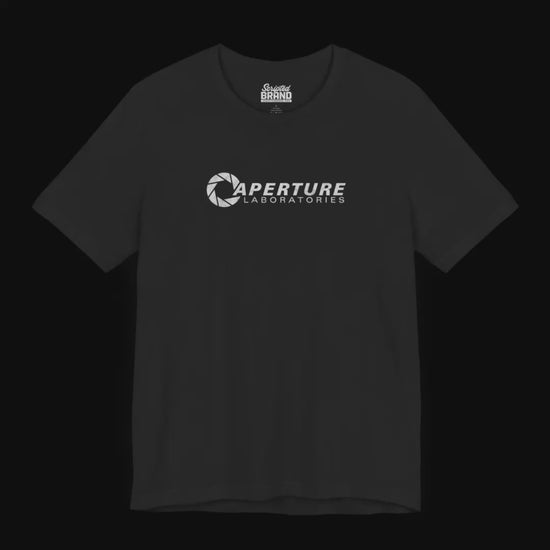 Video featuring soft Bella+Canvas t-shirts with the Aperture Laboratories logo from the video game Portal and Portal 2 in a vintage ink-stamped distressed style. 