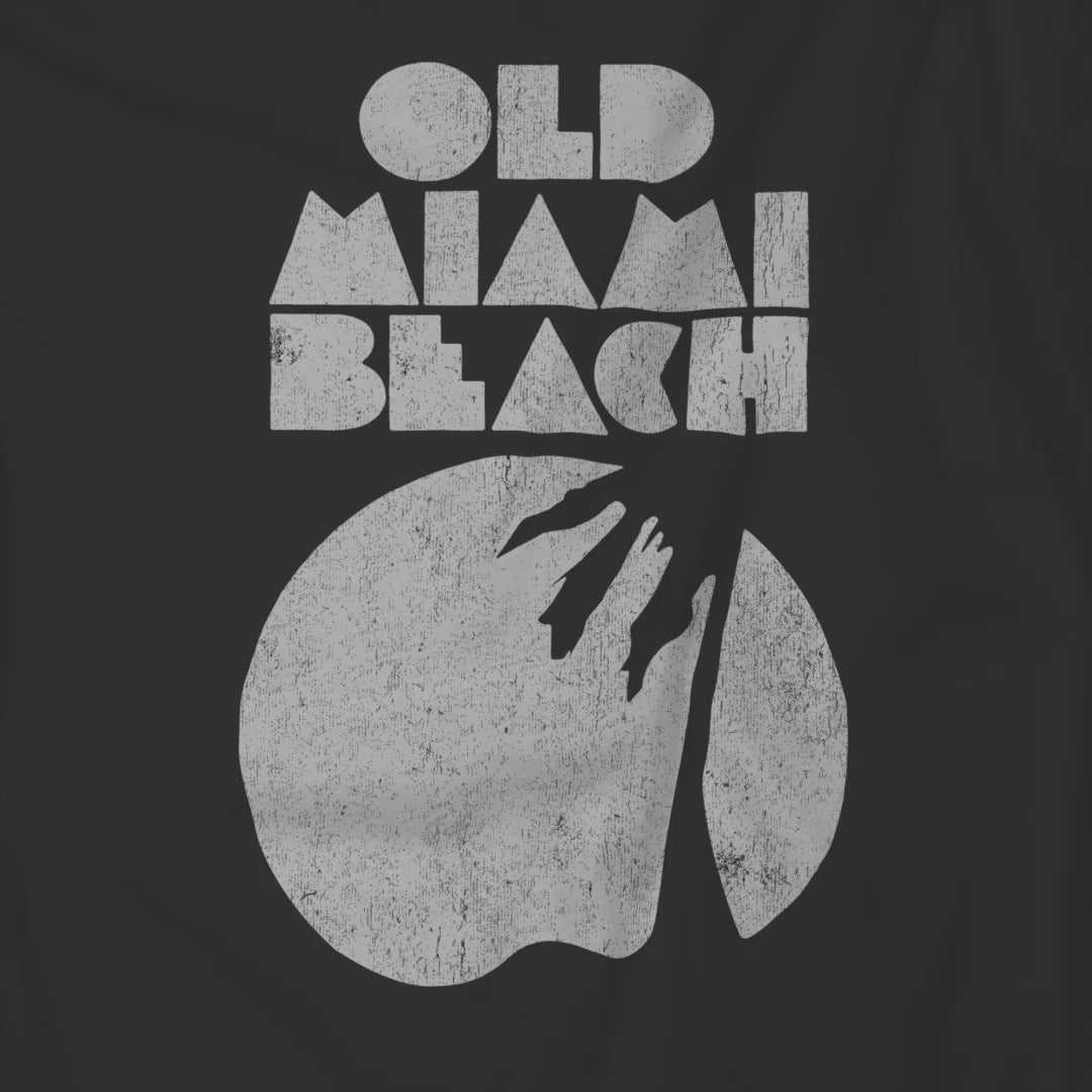 Video of Julia Garner's black T-shirt with distressed “Old Miami Beach” graphic in the movie Weapons.