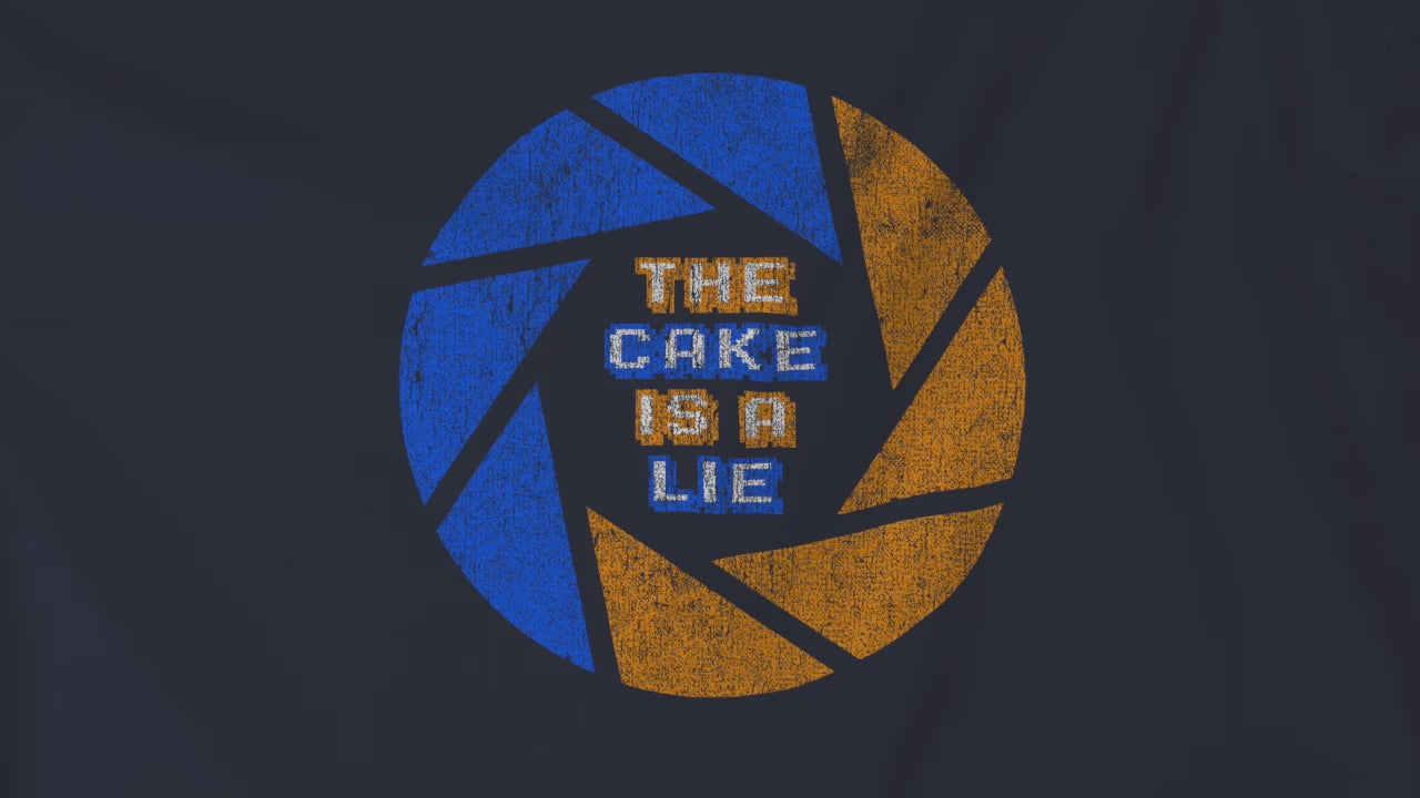 Video of soft Bella+Canvas 3001 short-sleeve t-shirts featuring the phrase The Cake Is a Lie, along with the Aperture Laboratories shutter logo from the video game Portal and Portal 2 in a vintage distressed style, sold by ScriptedBrand.