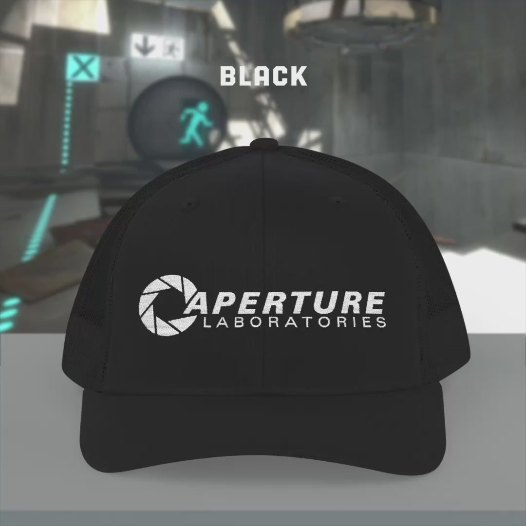 Video of Richardson 112 Snapback Trucker Caps featuring the embroidered logo of the fictional company Aperture Laboratories from the video game Portal and Portal 2, sold by ScriptedBrand. 