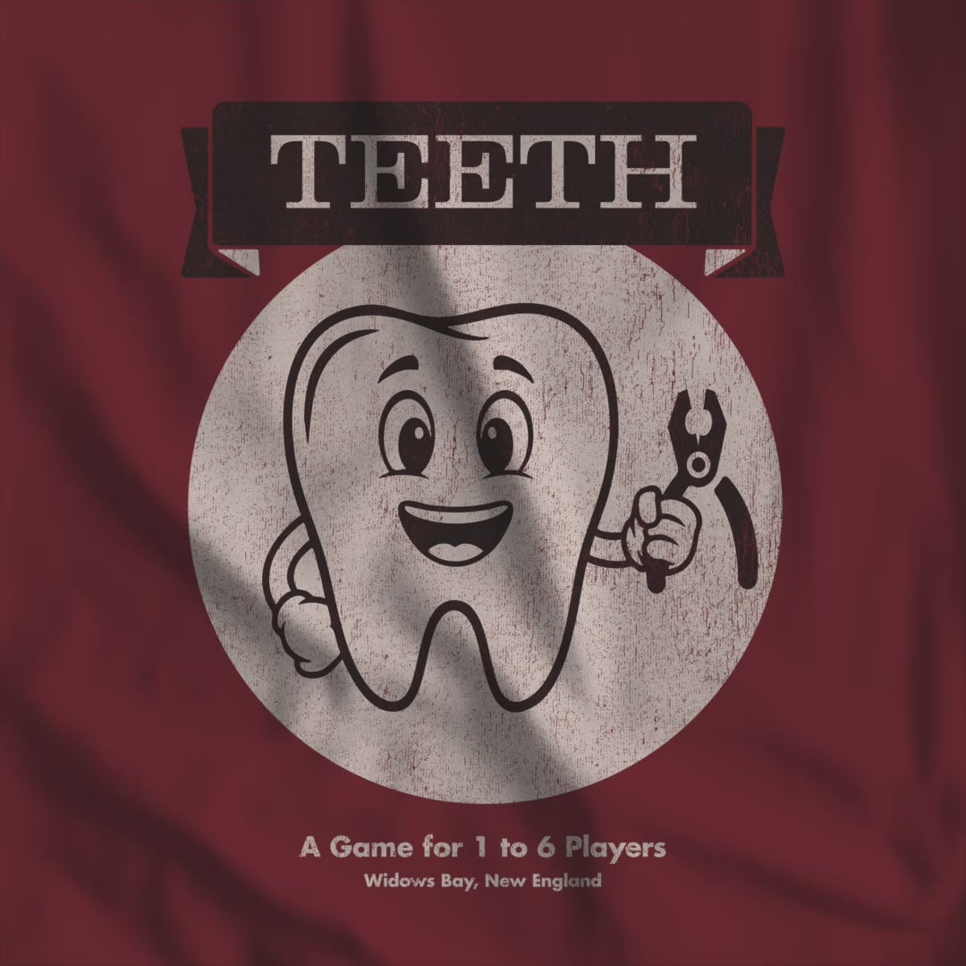 Video of Bella+Canvas tee with the vintage TEETH board game box cover from Widow's Bay, a smiling tooth holding pliers