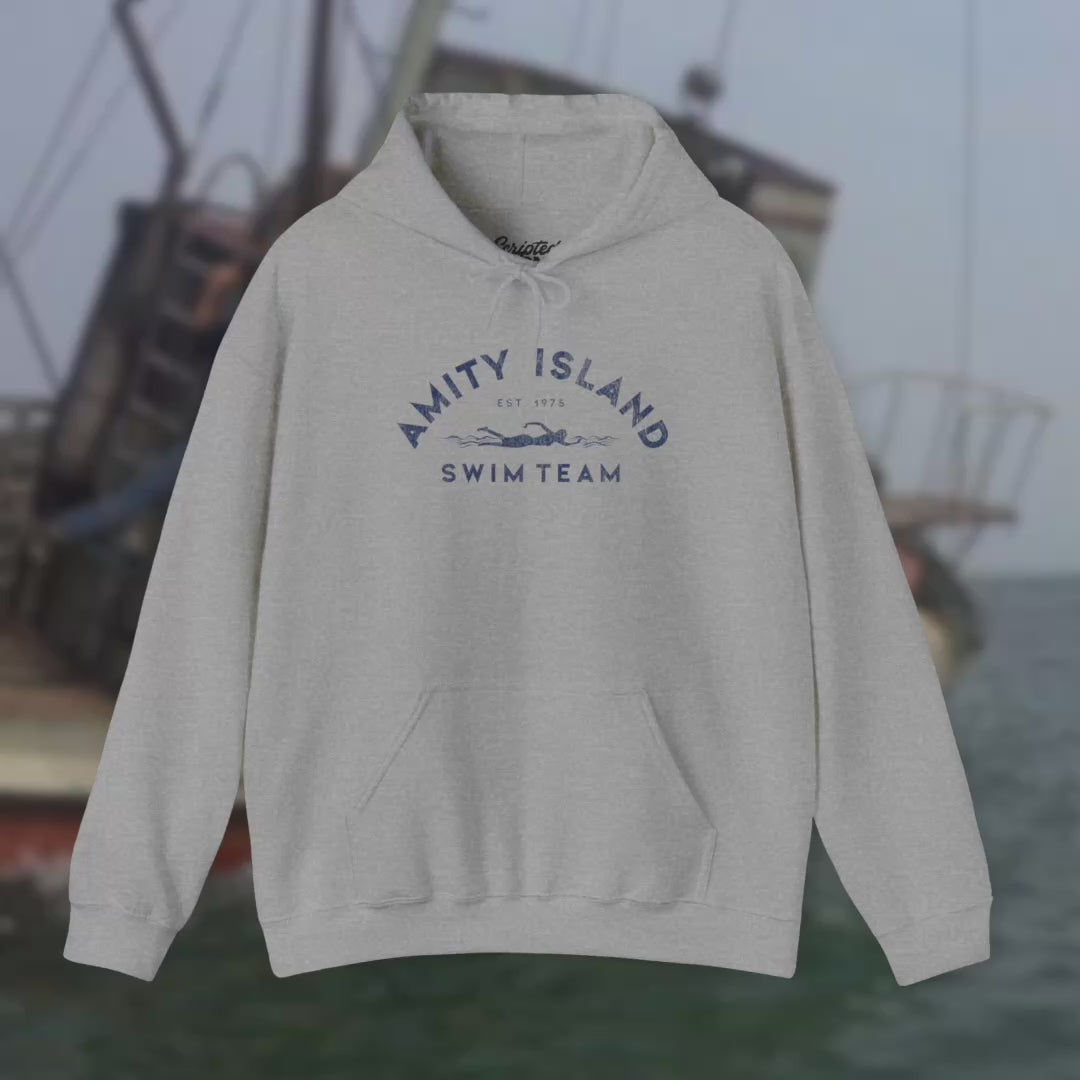View of Soft Unisex Hoodie Heavy Blend Hooded Sweatshirts featuring an Amity Island Swim Team logo graphic, designed by ScriptedBrand, and  inspired by the movie Jaws in a vintage distressed style.