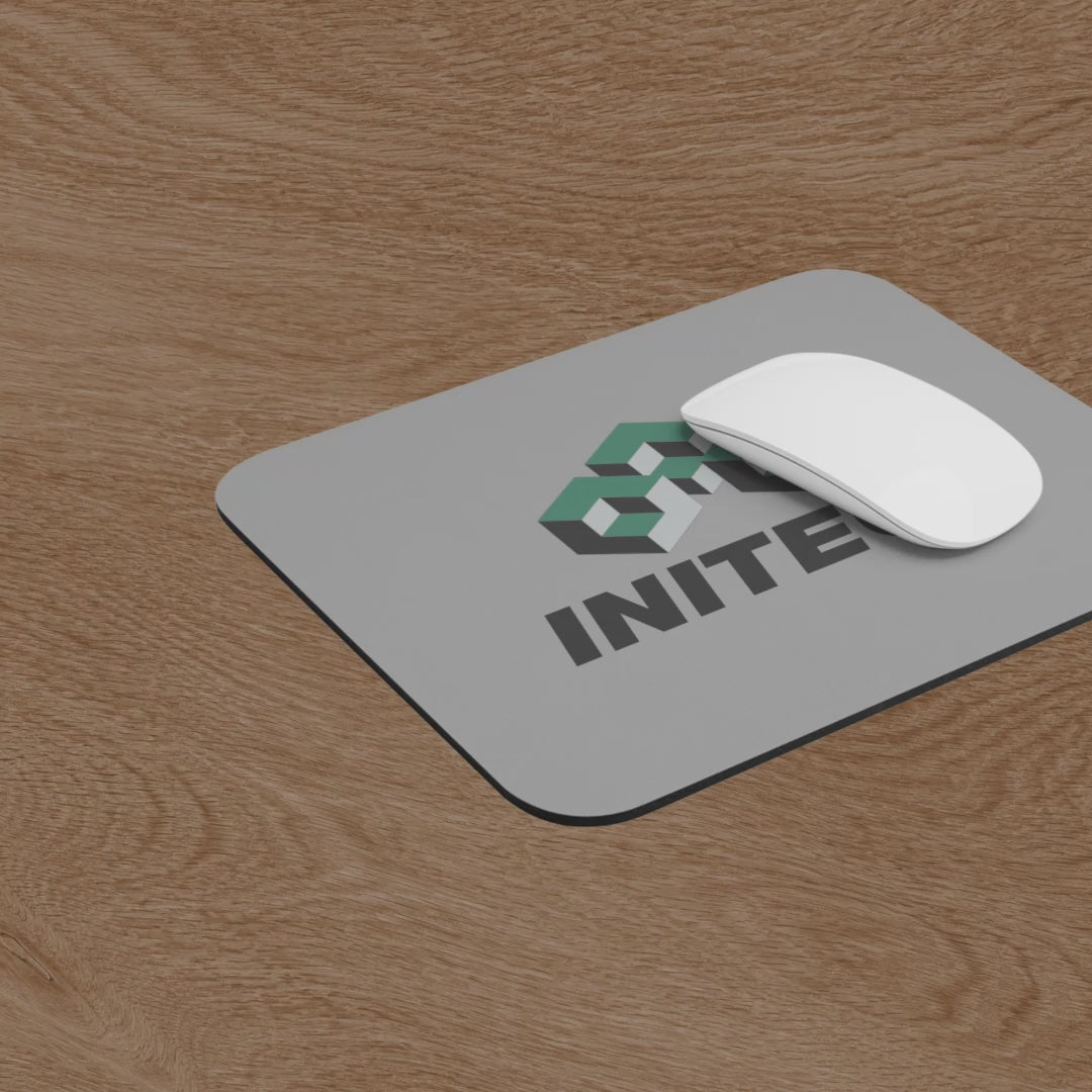 Video of Office Space Initech logo mouse pad on wooden desk, shown with a computer and mouse.