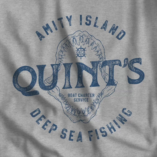 Video of t-shirt featuring the Quint's Deep Sea Fishing Boat Charters logo graphic inspired by the movie Jaws in a vintage distressed style.