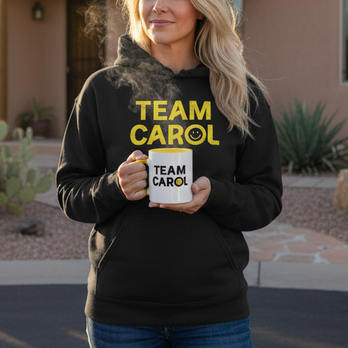 Woman wearing Pluribus Team Carol hoodie with yellow mug in New Mexico cul-de-sac